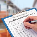 Someone filling a building inspection report